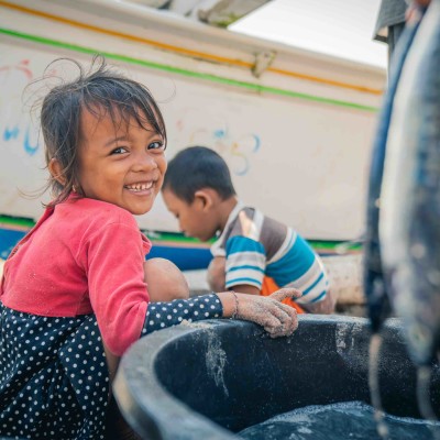 Local smile from kids on the beach in Amed thumbnail